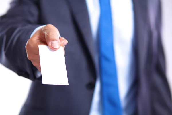 Mans hand showing business card - close seup shot on grey background — стоковое фото