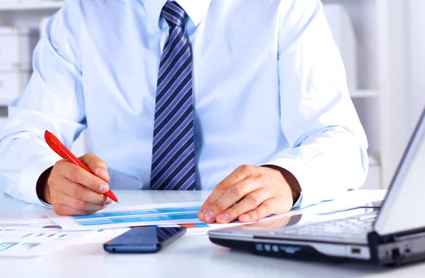 Businessman working at a desk computer graphics — Stock Photo, Image