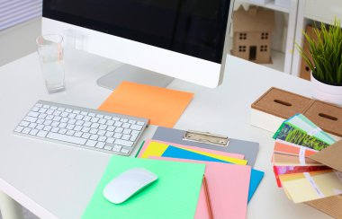 Bilgisayarı ve ahşap masasında akıllı telefonu olan bir ofis.