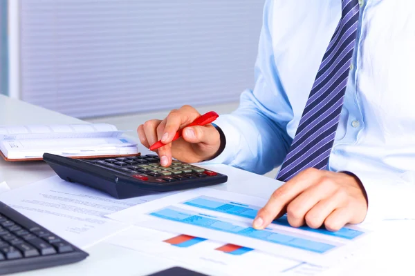 Businessman working at a desk computer graphics — Stock Photo, Image