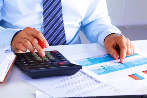 Businessman working at a desk computer graphics — Stock Photo, Image