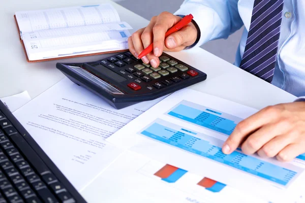 Businessman working at a desk computer graphics — Stock Photo, Image