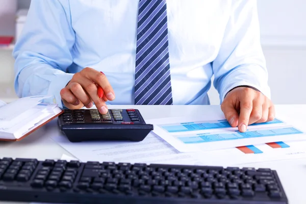 Businessman working at a desk computer graphics — Stock Photo, Image