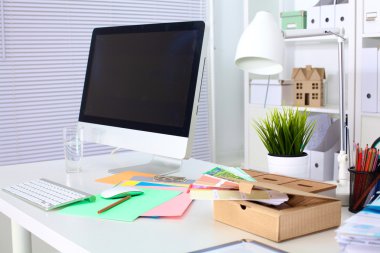 Bilgisayar ve evrak ile tasarımcı çalışma masası