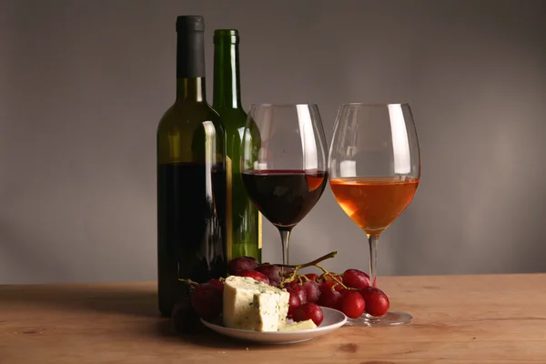 Fles wijn en glas op de tafel — Stockfoto