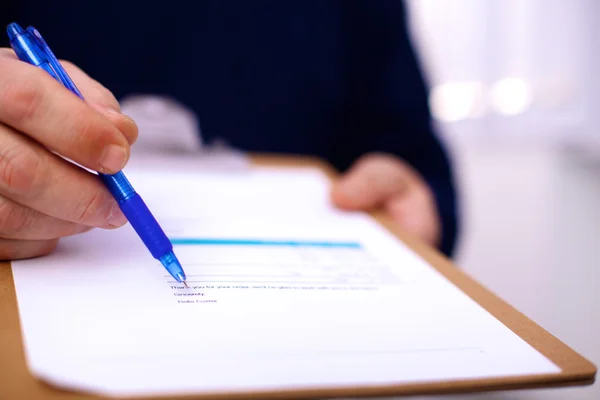 Businessman holding a blank white board — Stock Photo, Image