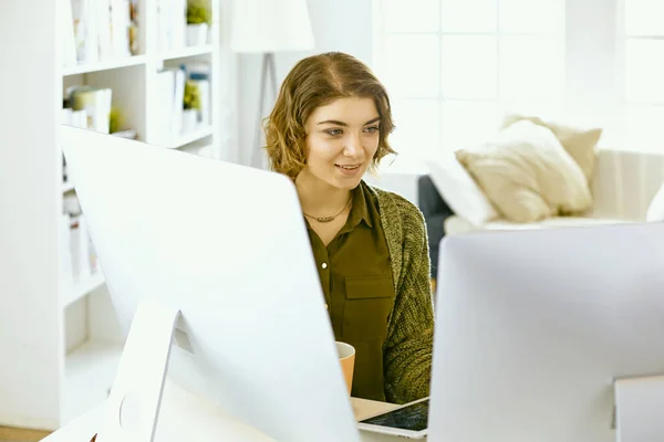 stock image Young woman working with graphic tablet in office