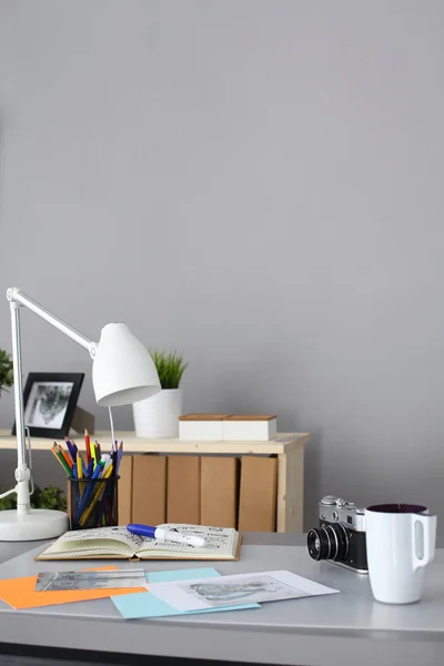 Designers table with camera and tools — Stock Photo, Image