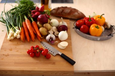 Taze organik sebze yemek pişirmek için bir bıçak ile bir tabloda