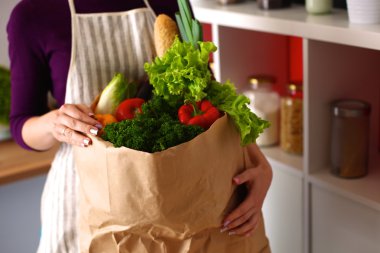 Çeşitli meyve ve sebze kahverengi bakkal çantada bir genç kız