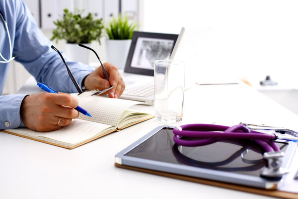 Male doctor sitting at his desk