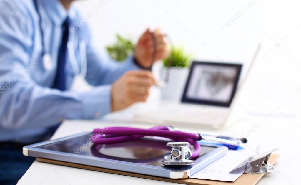 Doctor at work, close up of male doctor typing on a laptop