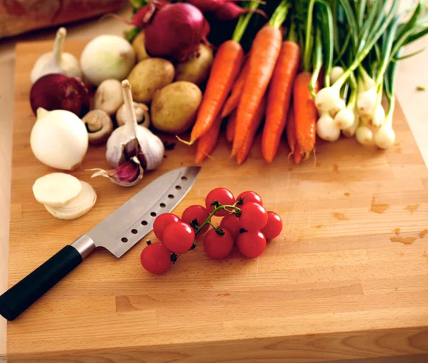 Свежие органические овощи на столе с ножом для приготовления пищи — стоковое фото