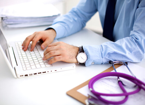 doctor with stethoscope on the patients admission at the table