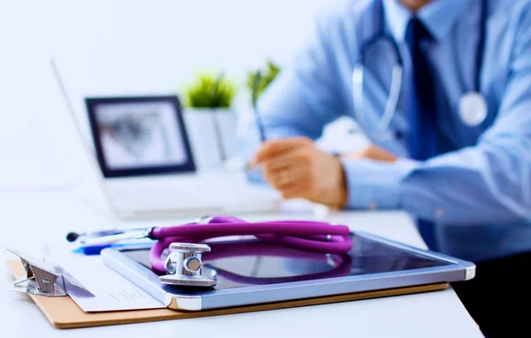 Doctor at work, close up of male doctor typing on a laptop