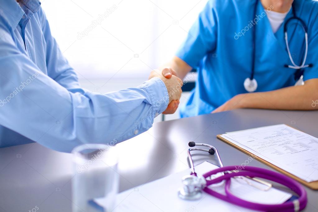 Medical doctor  sitting at table and looking patients roentgen