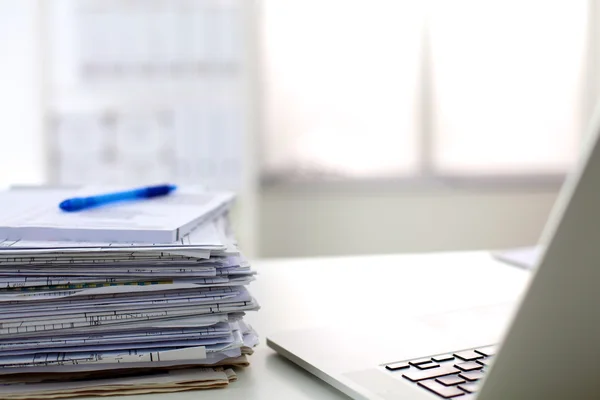 Stack of papers and glasses lying on table desaturated — Stock Photo, Image