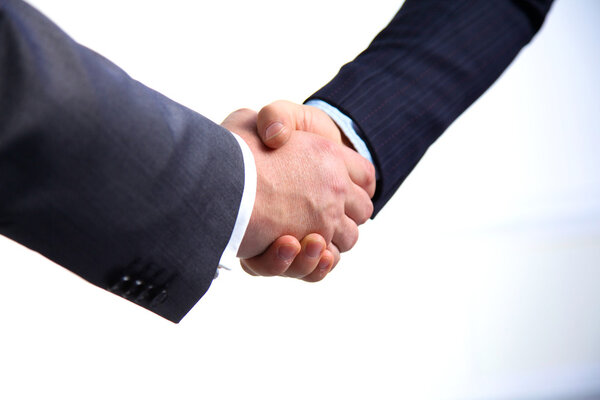 Business meeting at the table shaking hands conclusion of the contract