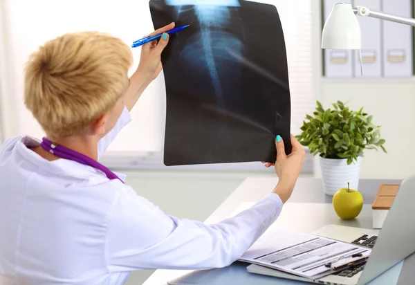 Confident female doctor examining accurately a rib cage x-ray — Stock Photo, Image