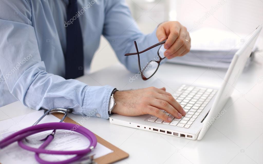Female doctor holding application form while consulting patient