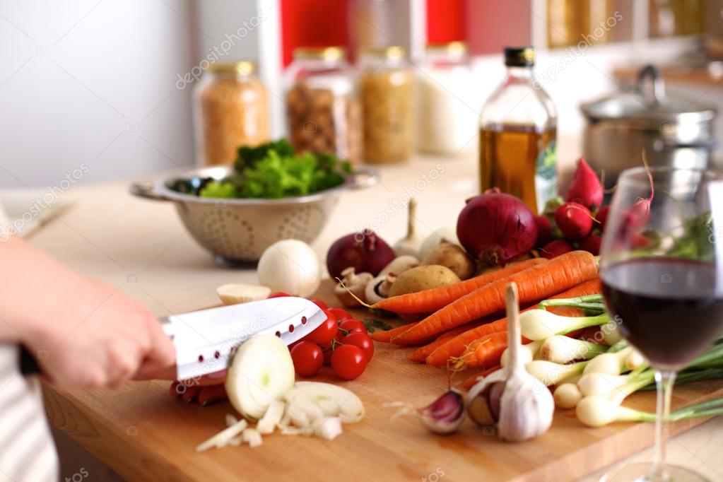 Cooks hands preparing vegetable salad - closeup shot