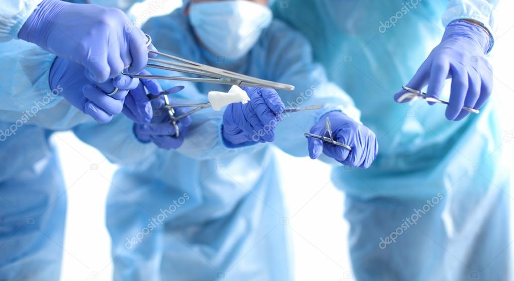 Team of surgeon in uniform perform operation on a patient at cardiac surgery clinic