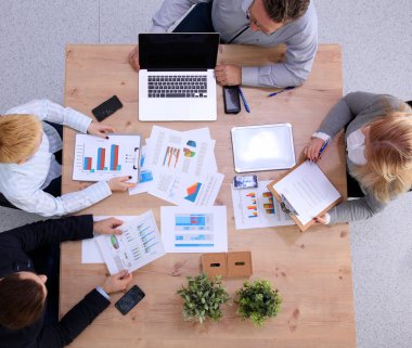 İş ortaklarının toplantıda belge ve fikirleri tartıştığı resim