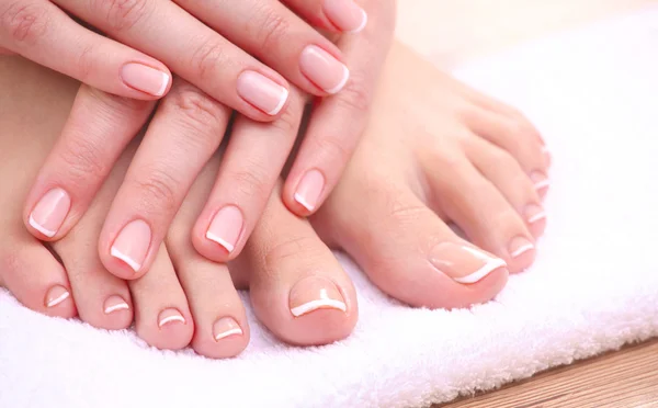 Closeup photo of a beautiful female feet with red pedicure isolated on white — Stock Photo, Image