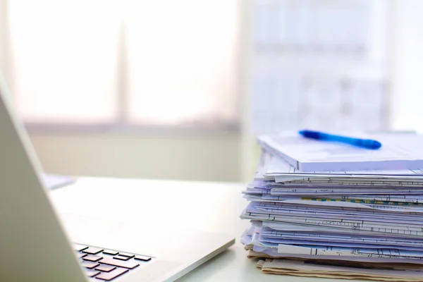 Stack of papers and glasses lying on table desaturated — Stock Photo, Image