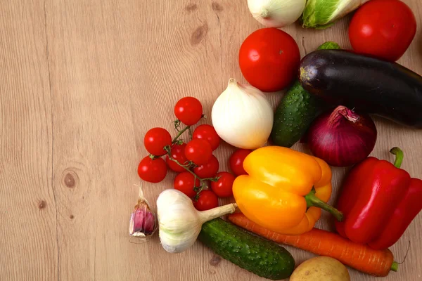 Pile of organic vegetables on a wooden table Stock Image