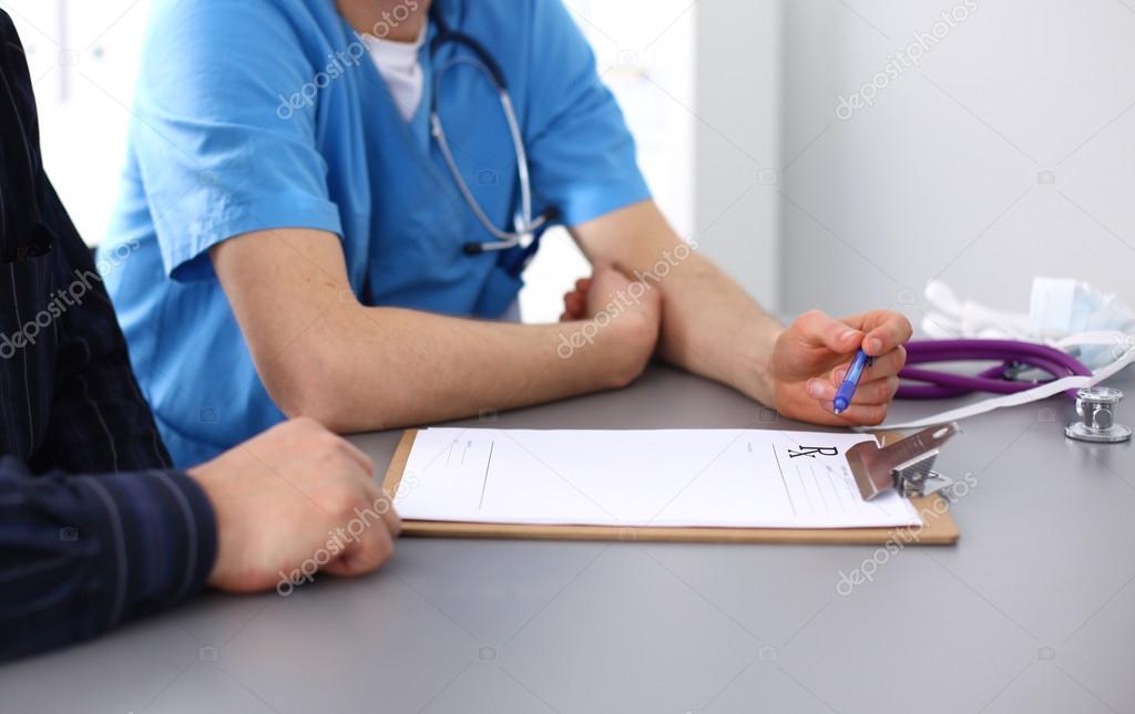 close up of patient and doctor taking notes