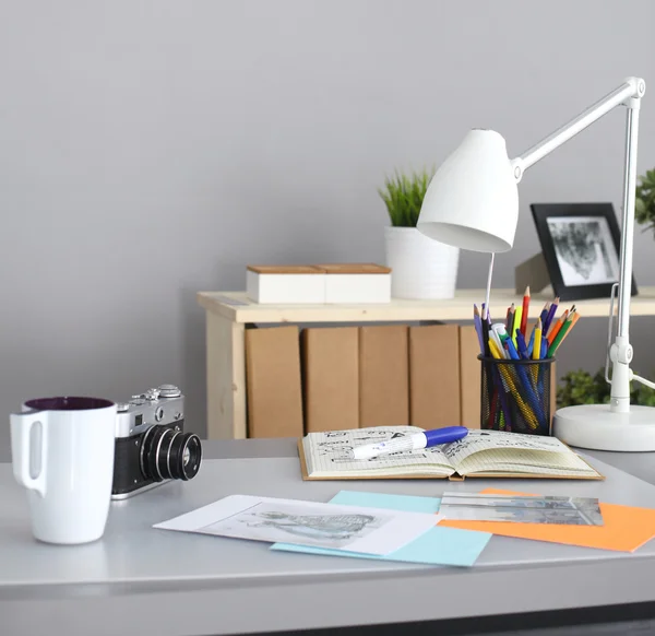 Designers table with camera and tools, cup — Stock Photo, Image