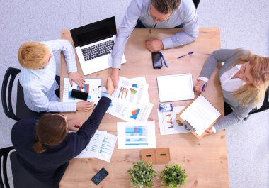 İş ortaklarının toplantıda belge ve fikirleri tartıştığı resim