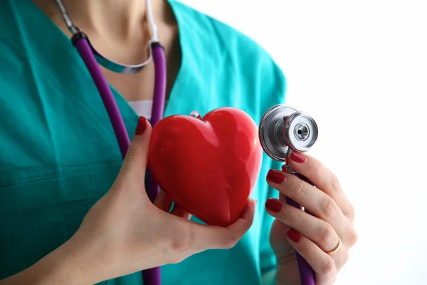 Stethoscope with heart in doctor hands, close-up — Stock Photo, Image