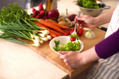 Genç kadın mutfakta yemek pişiriyor. Sağlıklı Yemek