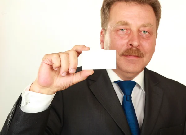 Mans hand showing business card - closeup shot on grey background