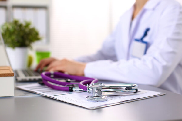 Portrait of happy medical doctor woman in office