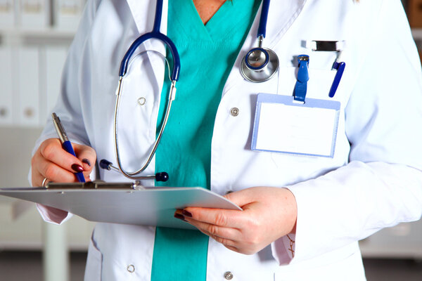 Portrait of happy medical doctor woman in office