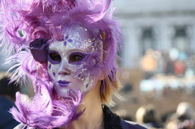 Venice, Italy - February 6, 2016: Unidentified persons with masks of the Venetian Carnival in Venice - Italy. St. Mark's Square on February 2016 clipart