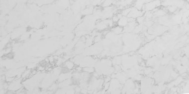 White marble slab with natural veining in various shades of light gray. Surface displays polished classic texture with intricate organic patterns stone creating an elegant and timeless background