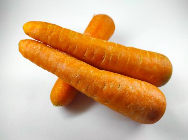 Photo of fresh carrots isolated on white background in mini studio