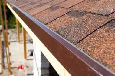 Closeup of new installed bitumen roof shingles. clipart