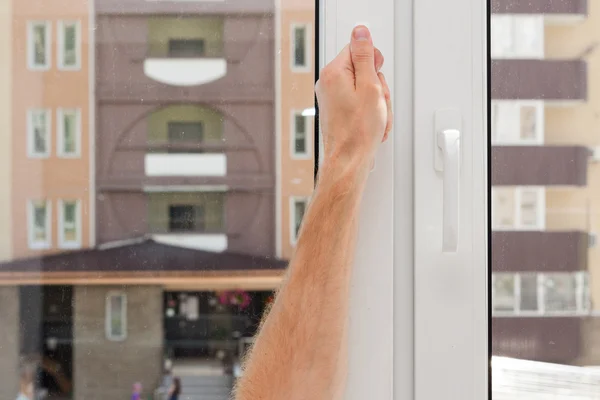 Man Hand opens a plastic pvc window — Stock Photo, Image