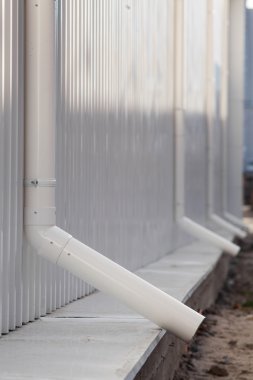 Yeni beyaz yağmur oluk bir bina beyaz metal levha ile 