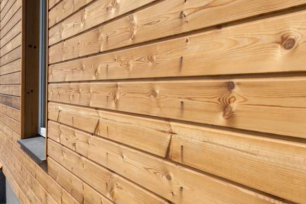 Close up of finally slatted natural wood on house — стоковое фото