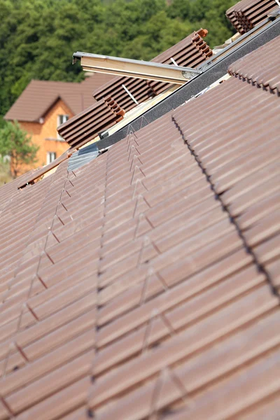 Closeup of new roof with skylight and natural red tile — Stock Photo, Image