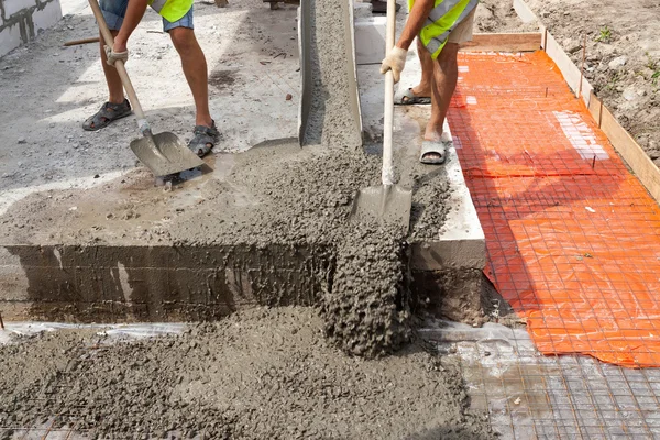 Mixed concrete pouring at construction site — Stock Photo, Image