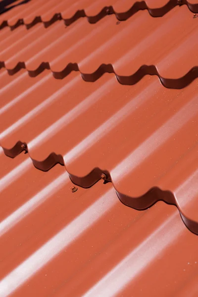 Red metal tile with screw — Stock Photo, Image