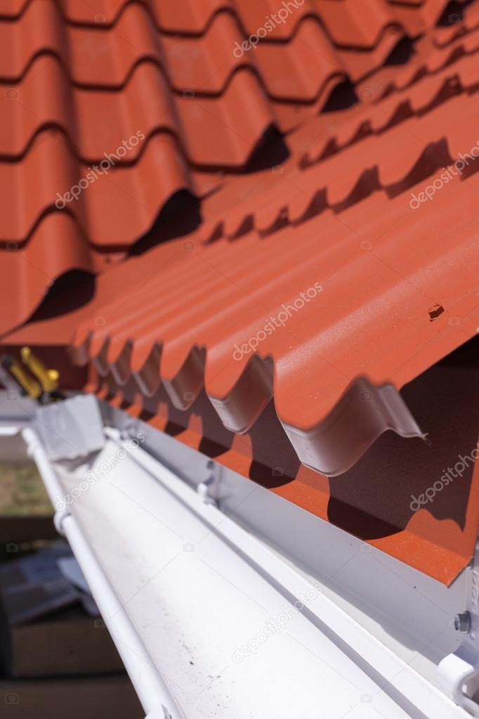 New red metal tile with white rain gutter