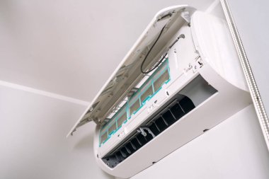 Oturma odasının tavanının altındaki yeni klimanın alçak açılı görüntüsü, kapat. Tamir ya da kurulum konseptleri AC, mevsimlik bakım, garanti hizmetleri